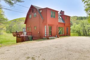 a large red house with a driveway in front of it at Serene Salisbury Rental Home on 26 Acres with Deck! in Salisbury