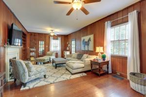 a living room with wooden walls and a ceiling fan at Quiet Ellaville Home with Patio and Outdoor Dining! 