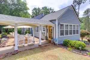 a blue house with a porch and a patio at Quiet Ellaville Home with Patio and Outdoor Dining! 