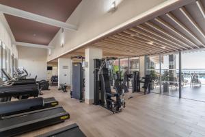 a gym with treadmills and cardio equipment in a building at Melia Alicante in Alicante