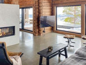 a living room with a couch and a fireplace at Holiday home Moen in Moen i Målselv