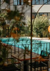 a view of a swimming pool from a hotel room at Best Western Le Galice Centre Ville in Aix-en-Provence