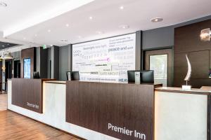 a reception desk with a large screen in a lobby at Premier Inn Essen City Limbecker Platz in Essen