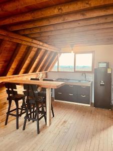 a kitchen with a wooden table and chairs in a room at ThanSam Cabaña in San Vicente