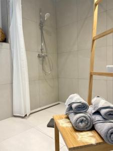 a bathroom with a shower with towels on a table at Hotel-Bistro-Europa in Merchweiler +72 photos