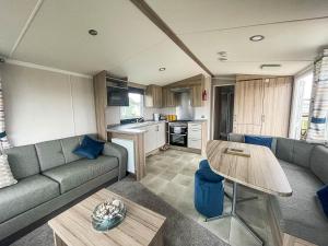 a living room with a couch and a table at 6 Berth Caravan With Decking At Sunnydale Holiday Park Ref 35243kg in Louth