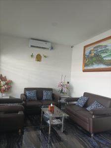 a living room with couches and a table at Hotel Berlian in Pontianak