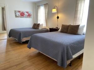 1 dormitorio con 2 camas y lámpara en The Whitetail Inn and Suites- Lincoln, en Lincoln