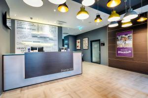a lobby of a dental office with a reception desk at Premier Inn Wiesbaden City Centre in Wiesbaden