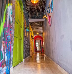 a hallway with brightly colored walls and a hallway with a hallwayngth at Urban Hostal Bar in Bucaramanga