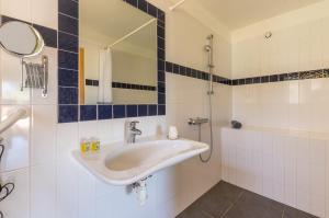 a bathroom with a sink and a mirror at Le Mas de Riri in Celles