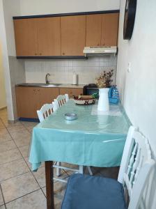 a kitchen with a table with chairs and a vase on it at Fabrika Apartment B2 in Vári