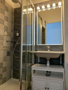 a bathroom with a sink and a mirror at Ambassadeur Hotel - Cherbourg Port de Plaisance in Cherbourg en Cotentin +98 photos