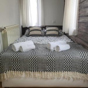 a bedroom with a bed with two towels on it at Boina House in Bansko