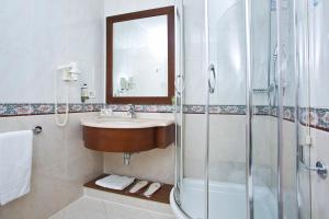 a bathroom with a sink and a shower at Vip's Motel Luxury Accommodation & Spa in Lonato
