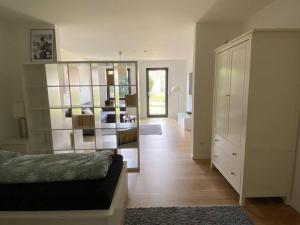 a living room with a bed and a large mirror at Terrassenwohnung in Siegburg in Siegburg