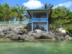 a house on the rocks in the water at Karlsson's Guesthouse in Larena