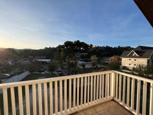 a wooden balcony with a view of a city at Hotel Solar da Montanha in Campos do Jordão