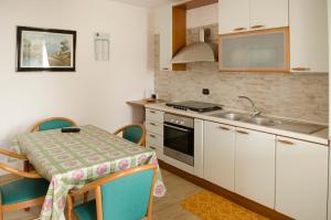 a small kitchen with a table and a sink at Art Village Residence in Bisceglie