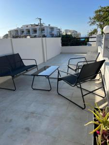 three chairs and a table on a roof at Sapphire home in Ixia