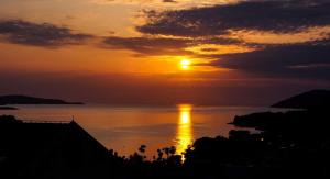 a sunset over a body of water at Apartments Viskovic in Hvar