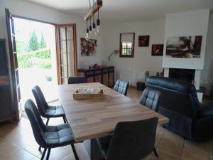 - une salle à manger avec une table et des chaises en bois dans l'établissement Charmante Maison à Vézac au cœur des 5 Châteaux en Dordogne, à Vézac