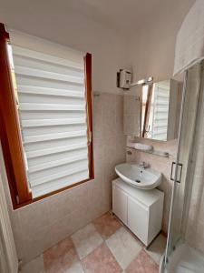 y baño blanco con lavabo y ducha. en Pao Apartment - Castelvecchio, en Verona