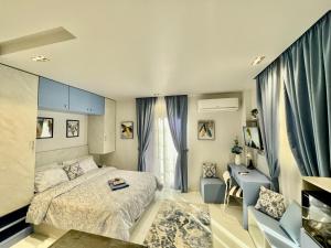 a bedroom with a bed and a desk and a chair at Luxury Studio House 589-6 in 6th Of October
