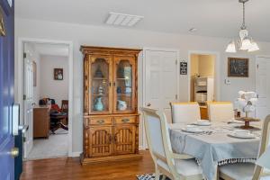 ein Esszimmer mit einem Tisch und einem Holzschrank in der Unterkunft Modern Bungalow Home with Mid-Century Flair in Springfield