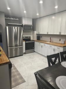 a kitchen with white cabinets and a stainless steel refrigerator at Cyclist Retreat in downtown Fruita, Colorado in Fruita