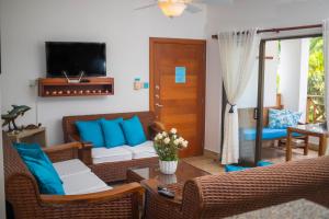 a living room with a couch and a table at Monserrat Residences in Las Terrenas