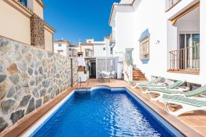 basen z leżakami i dom w obiekcie Villa Zoe w mieście Nerja