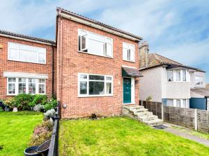 a brick house with a green yard at Pass the Keys Bright Spacious Home Away From Home With Parking in Abbey Wood