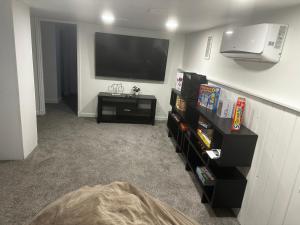 a living room with a flat screen tv on a wall at Cyclist Retreat in downtown Fruita, Colorado in Fruita