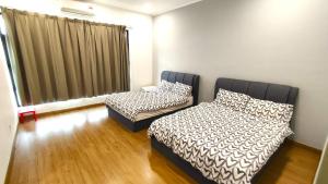 a bedroom with two beds and a window at A43 near Setia City Convention Centre & Bukit Raja in Shah Alam