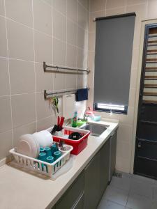 a kitchen counter with a sink and a dish drying rack at A43 near Setia City Convention Centre & Bukit Raja in Shah Alam