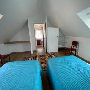a bedroom with two blue beds in a attic at Penty á Plogoff-Pointe du Raz in Plogoff
