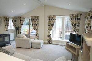 a living room with couches and a flat screen tv at Blackfoot Lodge in Felton