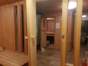 a room with wooden walls and wooden doors in a room at Prada Laax by Quokka 360 - building with sauna in Laax