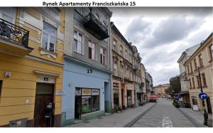 an empty street in a city with buildings at Apartamenty Rynek K in Przemyśl