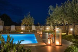 a pool with lights in a backyard at night at Villa RINA - 3 bedroom with private pool in Krk