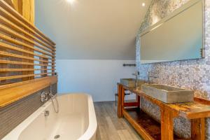 une salle de bain avec une baignoire et un lavabo dans l'établissement Buytenplaats Villa 187, à De Koog 19 autres photos