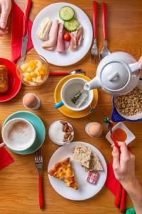 a table with plates of food and a cup of coffee at Hôtel Crayon Rouge in Paris