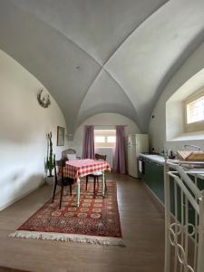 a kitchen with a table in the middle of a room at Antica Casa Fenaroli in Iseo