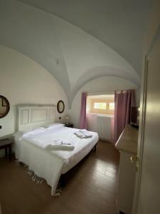 a bedroom with a large white bed in a room at Antica Casa Fenaroli in Iseo