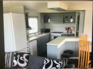 a small kitchen with a stove and a counter at HAVEN THORPE PARK 6 Berth Caravan in Cleethorpes Waterside FREE WI FI in Cleethorpes