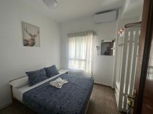 - une chambre avec un lit et une couette bleue dans l'établissement Hostal Arrate, à Madrid