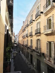 an empty street in a city with buildings at Apartment in the Center of Madrid in Madrid