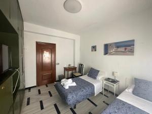 Habitación de hotel con cama y sofá en Hostal Arrate en Madrid