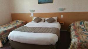 Postel nebo postele na pokoji v ubytování Hotel De La Mer